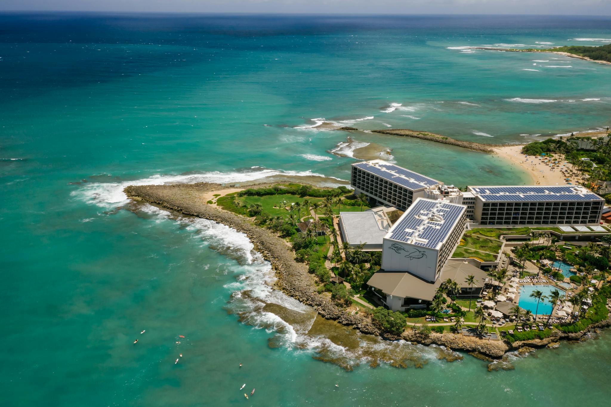 Breathtaking aerial view of Turtle Bay Resort on Oahu's coast, with vibrant sea and lush landscapes.