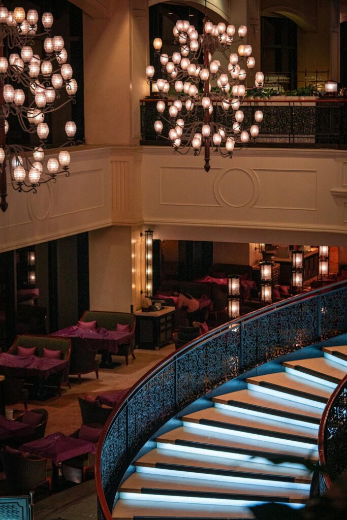 Elegant hotel interior with a grand staircase and ornate chandeliers in Pasay, Philippines.