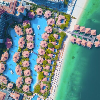 Stunning aerial shot of a luxurious Dubai beachfront resort with swimming pools.