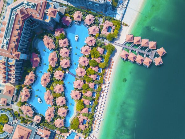 Stunning aerial shot of a luxurious Dubai beachfront resort with swimming pools.